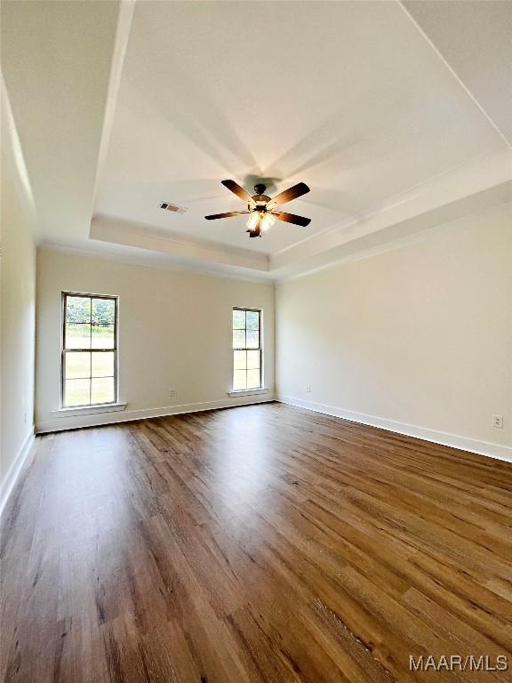 60 Serene Ln, Wetumpka, AL 36093 - spare room featuring a raised ceiling, dark wood-style flooring, and a ceiling fan