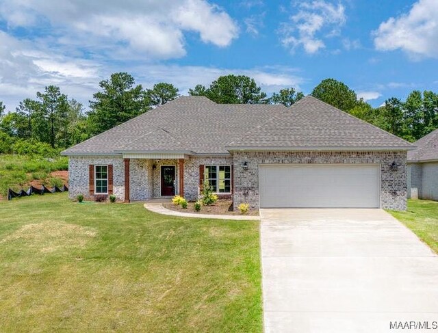 60 Serene Ln, Wetumpka, AL 36093 - view of front of property with a garage, a front lawn, concrete driveway, and a shingled roof