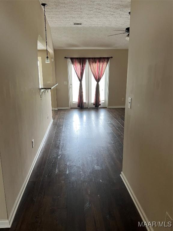 19 High Cotton Ct, Wetumpka, AL 36092 - spare room featuring dark wood-style flooring, a ceiling fan, baseboards, and a textured ceiling