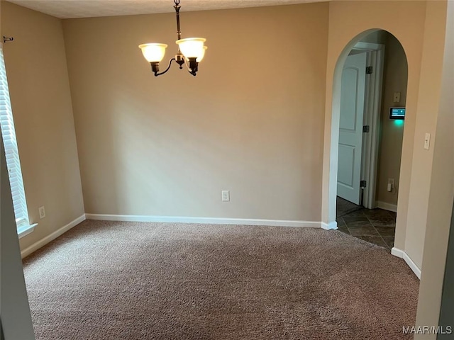19 High Cotton Ct, Wetumpka, AL 36092 - unfurnished room with arched walkways, dark colored carpet, a chandelier, and baseboards