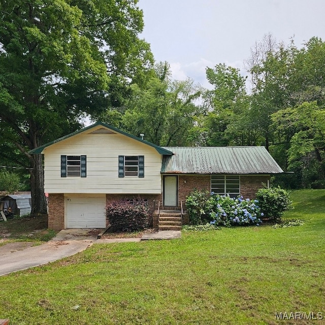 1018 Hillcrest Dr, Weaver, AL 36277 - split level home featuring brick siding, concrete driveway, a front yard, and a garage