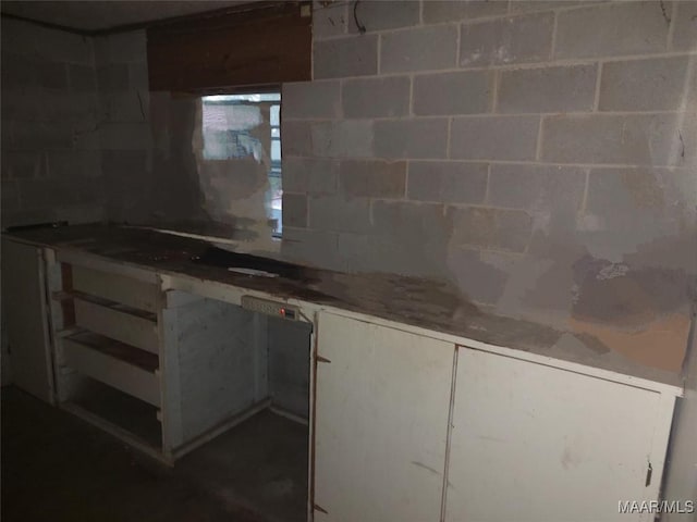 1018 Hillcrest Dr, Weaver, AL 36277 - kitchen with concrete block wall and white cabinetry