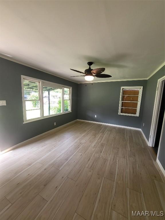 439 Gardendale Dr, Montgomery, AL 36110 - spare room with wood finished floors, ornamental molding, a ceiling fan, and baseboards