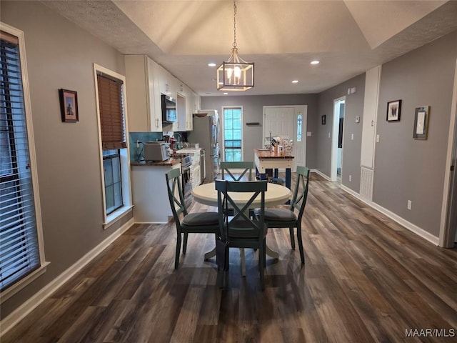2112 Station Ct, Montgomery, AL 36116 - dining area featuring dark wood-type flooring, a chandelier, baseboards, recessed lighting, and lofted ceiling