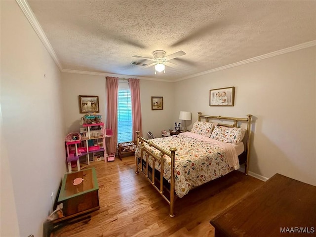 530 Palmquist Dr, Selma, AL 36701 - bedroom featuring a textured ceiling, wood finished floors, crown molding, and a ceiling fan
