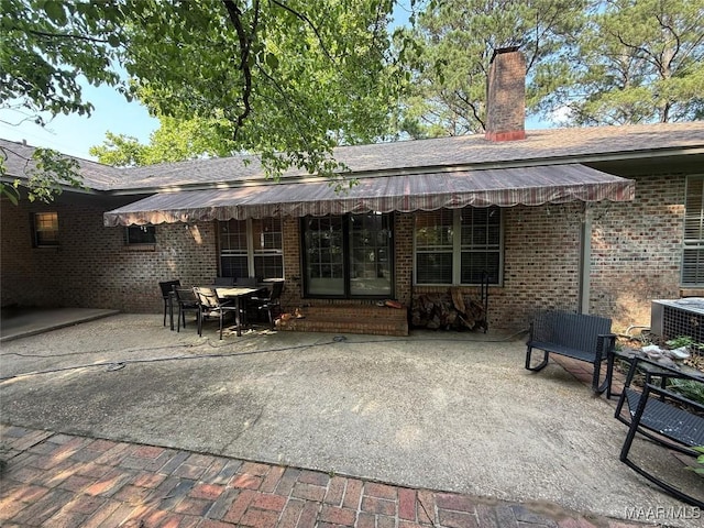 530 Palmquist Dr, Selma, AL 36701 - back of house with a patio area, brick siding, a chimney, and entry steps