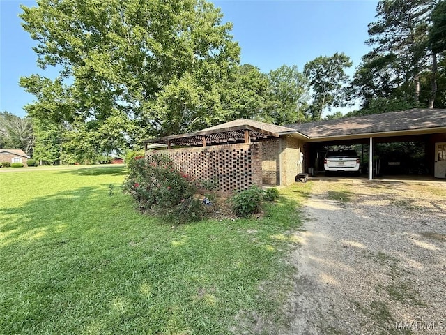 530 Palmquist Dr, Selma, AL 36701 - view of side of home with a carport, dirt driveway, and a yard