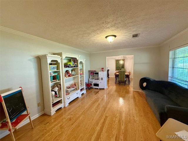 530 Palmquist Dr, Selma, AL 36701 - living area with light wood-type flooring, crown molding, and a textured ceiling