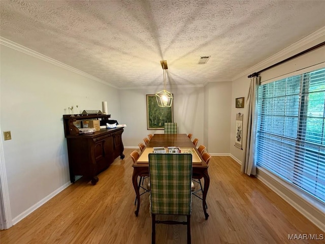 530 Palmquist Dr, Selma, AL 36701 - dining area with wood finished floors, a textured ceiling, and crown molding