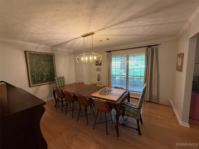 530 Palmquist Dr, Selma, AL 36701 - dining room with a chandelier, wood finished floors, a textured ceiling, and ornamental molding