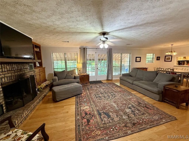 530 Palmquist Dr, Selma, AL 36701 - living area with a textured ceiling, a chandelier, light wood-style floors, ceiling fan, and healthy amount of natural light