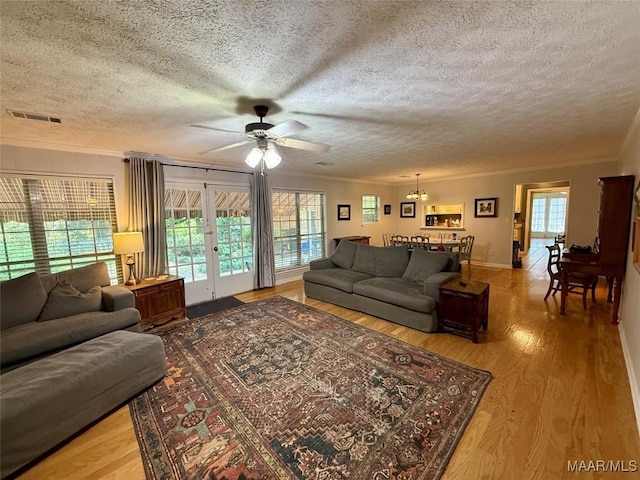 530 Palmquist Dr, Selma, AL 36701 - living room featuring crown molding, french doors, a textured ceiling, ceiling fan, and light wood finished floors