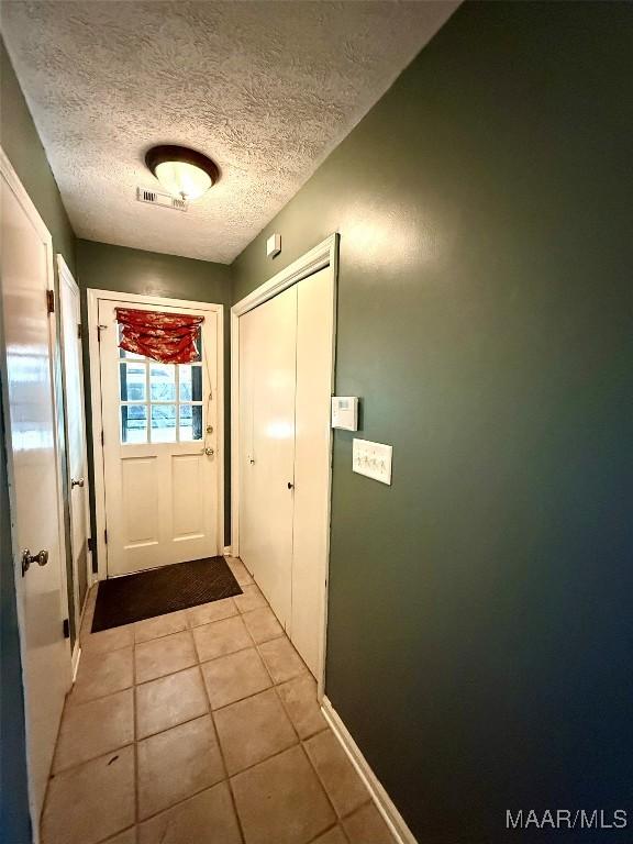 530 Palmquist Dr, Selma, AL 36701 - entryway featuring light tile patterned floors and a textured ceiling