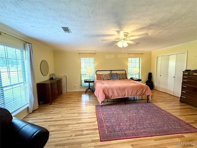 530 Palmquist Dr, Selma, AL 36701 - bedroom featuring crown molding, light wood finished floors, multiple windows, a textured ceiling, and ceiling fan