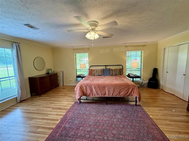 530 Palmquist Dr, Selma, AL 36701 - bedroom with light wood finished floors, ornamental molding, a textured ceiling, and a ceiling fan