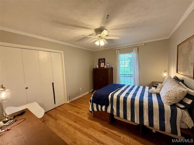 530 Palmquist Dr, Selma, AL 36701 - bedroom featuring a textured ceiling, wood finished floors, ceiling fan, a closet, and crown molding