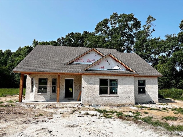 22 Mockingbird Ln, Eclectic, AL 36024 - property under construction featuring brick siding, a porch, and roof with shingles