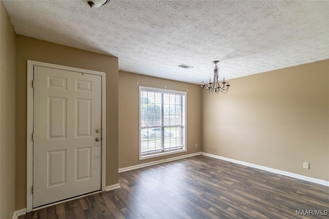 242 Preakness Path, Montgomery, AL 36117 - entryway featuring a chandelier, dark wood-type flooring, baseboards, and a textured ceiling