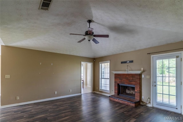 242 Preakness Path, Montgomery, AL 36117 - unfurnished living room featuring a textured ceiling, a ceiling fan, dark wood-style floors, baseboards, and a fireplace