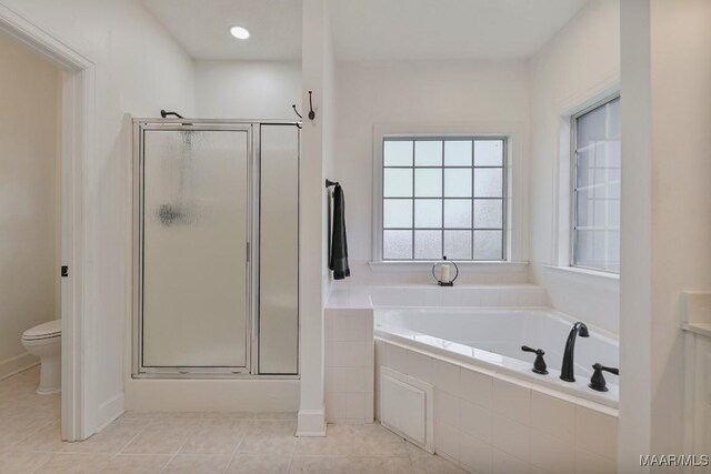 505 Mountain Ridge Rd, Millbrook, AL 36054 - bathroom featuring toilet, a garden tub, a shower stall, and tile patterned flooring