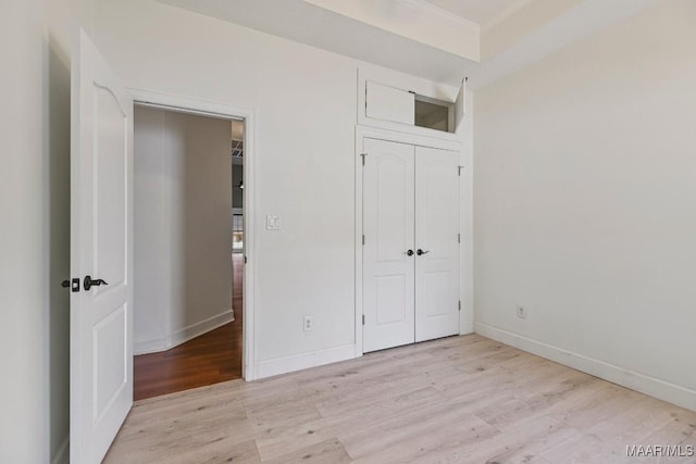 505 Mountain Ridge Rd, Millbrook, AL 36054 - unfurnished bedroom with light wood-type flooring, baseboards, crown molding, and a closet
