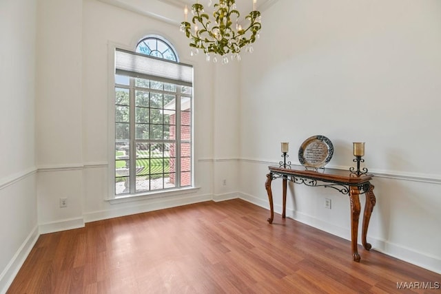 505 Mountain Ridge Rd, Millbrook, AL 36054 - empty room featuring a chandelier, wood finished floors, and baseboards
