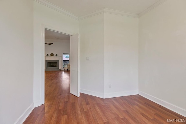505 Mountain Ridge Rd, Millbrook, AL 36054 - unfurnished room featuring wood finished floors, crown molding, baseboards, and a fireplace