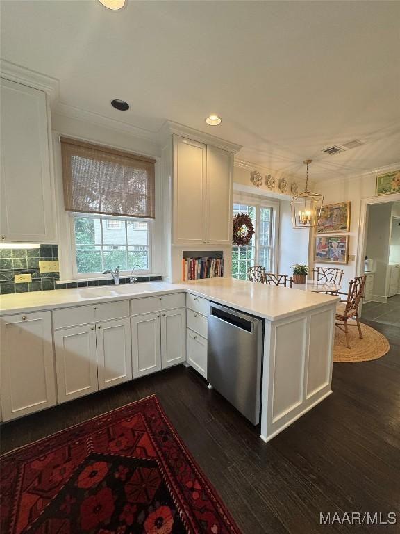 2081 Myrtlewood Dr, Montgomery, AL 36111 - kitchen featuring stainless steel dishwasher, a chandelier, dark wood-style flooring, white cabinets, and a peninsula