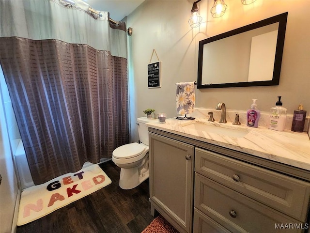 445 W Hickory Grove Rd, Lapine, AL 36046 - full bath with wood finished floors, vanity, toilet, and shower / bath combo with shower curtain