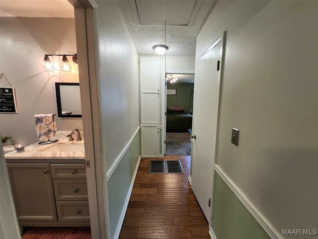 445 W Hickory Grove Rd, Lapine, AL 36046 - hallway featuring a sink, attic access, dark wood-style flooring, and baseboards