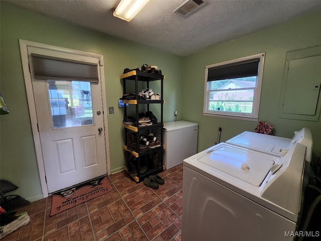 445 W Hickory Grove Rd, Lapine, AL 36046 - washroom with washer and dryer, electric panel, a textured ceiling, baseboards, and brick patterned floors