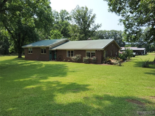 445 W Hickory Grove Rd, Lapine, AL 36046 - view of front of property with a chimney, a front lawn, brick siding, and metal roof
