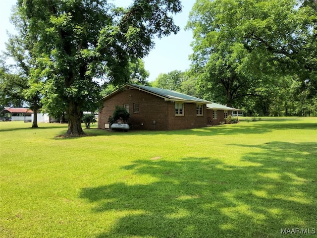 445 W Hickory Grove Rd, Lapine, AL 36046 - view of side of home featuring a yard and brick siding