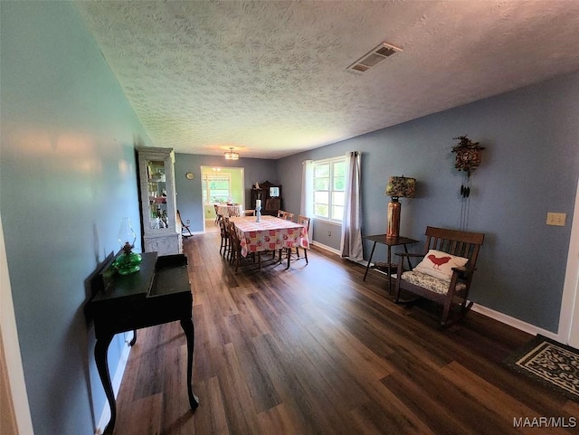 445 W Hickory Grove Rd, Lapine, AL 36046 - dining area with a textured ceiling, dark wood-type flooring, and baseboards