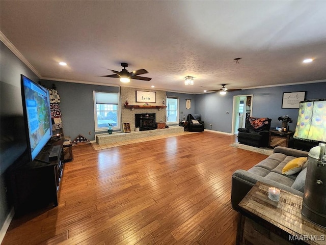 445 W Hickory Grove Rd, Lapine, AL 36046 - living room with ceiling fan, crown molding, wood finished floors, a fireplace, and recessed lighting