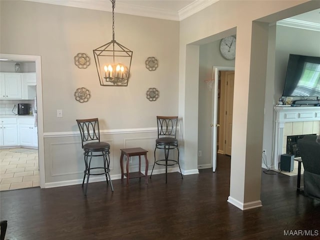 2320 Halcyon Downs Loop, Montgomery, AL 36117 - dining space with crown molding, a chandelier, wood finished floors, and a tile fireplace