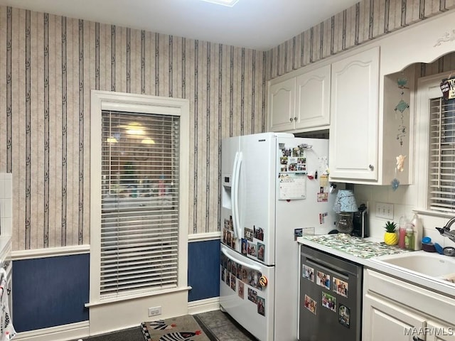 1915 Emerald Mountain Pkwy, Wetumpka, AL 36093 - kitchen with dishwasher, white fridge with ice dispenser, white cabinets, a sink, and wallpapered walls