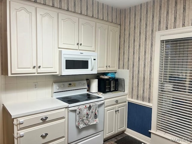 1915 Emerald Mountain Pkwy, Wetumpka, AL 36093 - kitchen featuring white appliances, wallpapered walls, light countertops, and white cabinetry