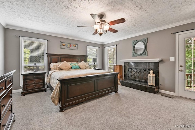 594 Lewis Rd, Deatsville, AL 36022 - bedroom with light carpet, access to outside, a textured ceiling, ornamental molding, and a tiled fireplace