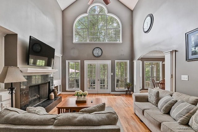 594 Lewis Rd, Deatsville, AL 36022 - living room featuring high vaulted ceiling, ornate columns, a ceiling fan, arched walkways, and a high end fireplace