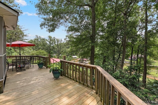 594 Lewis Rd, Deatsville, AL 36022 - wooden deck featuring outdoor dining space and view of scattered trees