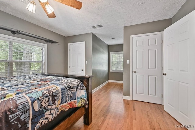 594 Lewis Rd, Deatsville, AL 36022 - bedroom featuring light wood-type flooring, baseboards, a textured ceiling, and ceiling fan