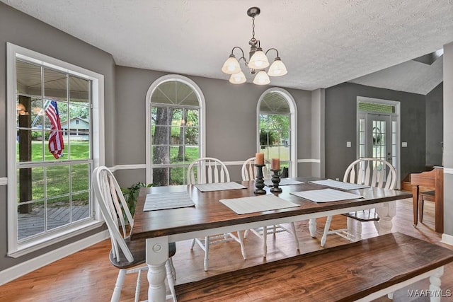 594 Lewis Rd, Deatsville, AL 36022 - dining room with a chandelier, a textured ceiling, baseboards, and wood finished floors