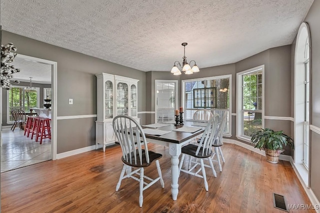 594 Lewis Rd, Deatsville, AL 36022 - dining room featuring baseboards, a chandelier, wood finished floors, and a textured ceiling