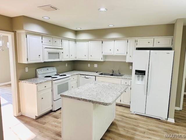 6118 Helga Pl, Montgomery, AL 36117 - kitchen featuring white appliances, a sink, white cabinetry, light wood finished floors, and recessed lighting