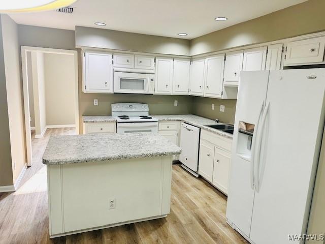 6118 Helga Pl, Montgomery, AL 36117 - kitchen featuring white appliances, a kitchen island, white cabinets, and recessed lighting