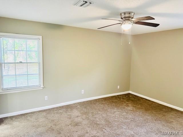 6118 Helga Pl, Montgomery, AL 36117 - empty room with a ceiling fan, dark colored carpet, and baseboards