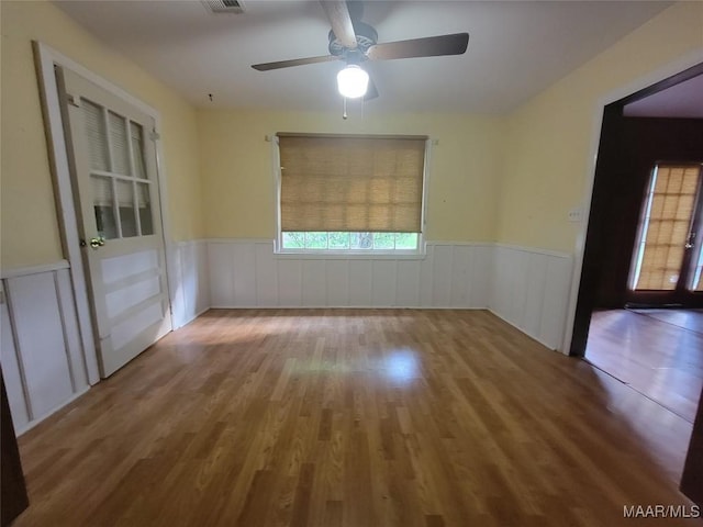 55 County Road 65th Rd, Valley Grande, AL 36701 - unfurnished room with wood finished floors, a wainscoted wall, and ceiling fan
