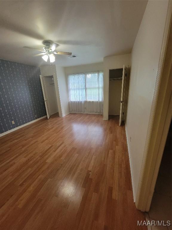 55 County Road 65th Rd, Valley Grande, AL 36701 - unfurnished bedroom with wood finished floors, baseboards, and a ceiling fan