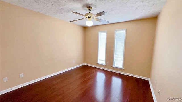 6616 Chaprice Ln, Montgomery, AL 36117 - unfurnished room featuring baseboards, plenty of natural light, dark wood-style floors, a ceiling fan, and a textured ceiling